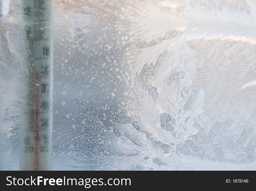 Beautiful frosty window with thermometer, good background for greeting-cards, thermometer is out of focus, focal point on frosting. Beautiful frosty window with thermometer, good background for greeting-cards, thermometer is out of focus, focal point on frosting.
