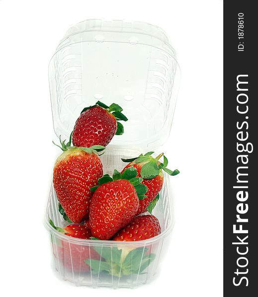 Fresh red strawberry on plastic box on white background