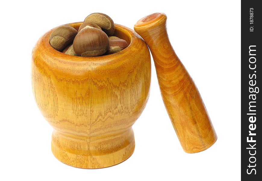 Wooden  mortar with pestle standing outside and chestnuts in the bowl on white background. Wooden  mortar with pestle standing outside and chestnuts in the bowl on white background