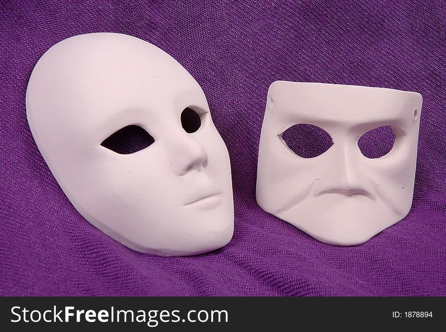 Couple of Venice carnival mask on purple sheet