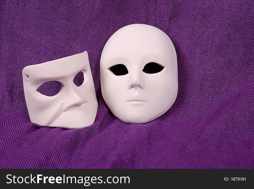 Couple of Venice carnival mask on purple sheet