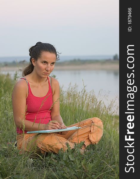 Girl paint on the river's coast