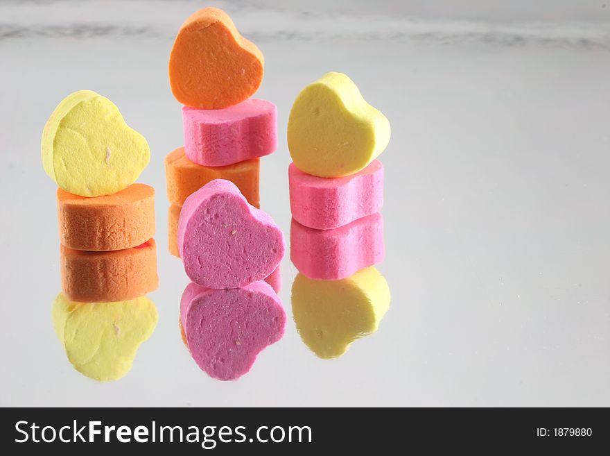 Stacked Candy Hearts on reflective background. Stacked Candy Hearts on reflective background.