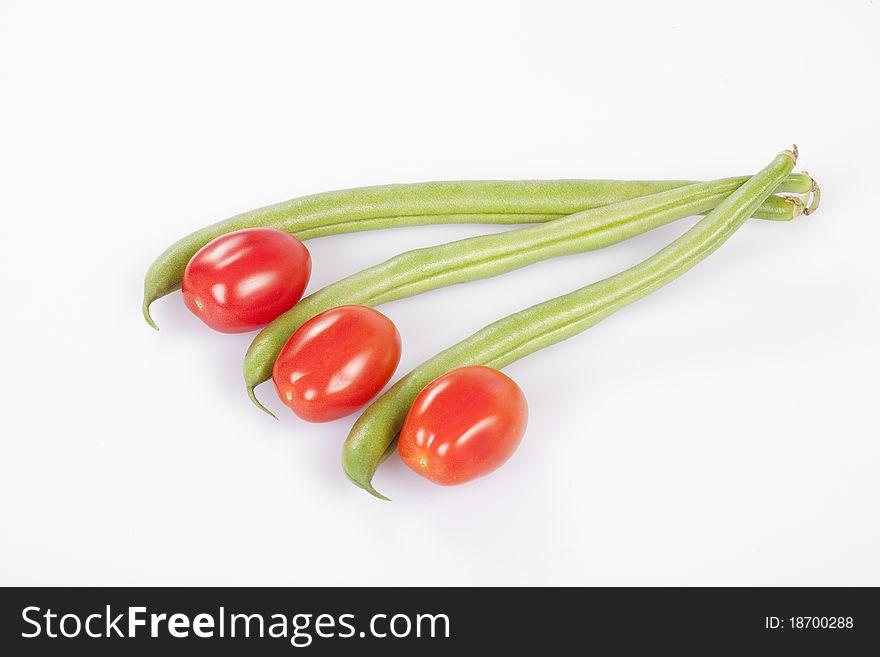 Red cherry tomatoes with French beans clipping path. Red cherry tomatoes with French beans clipping path