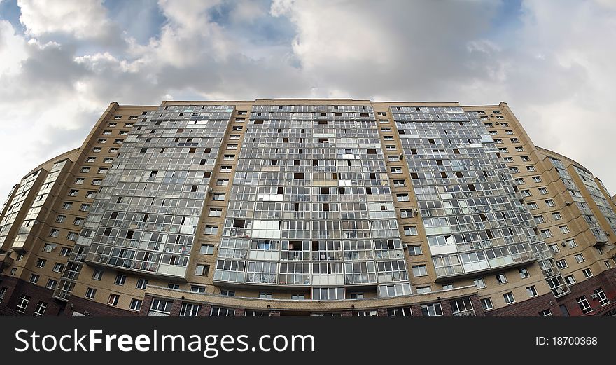 An apartment high-rise building of yellow brick. An apartment high-rise building of yellow brick