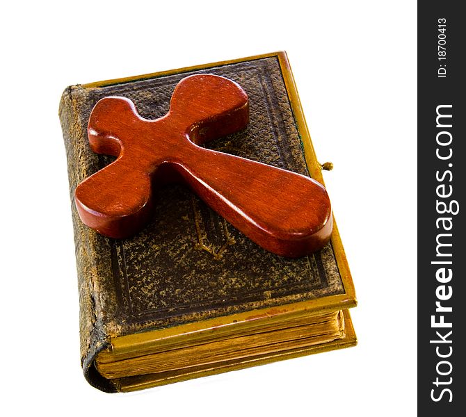 Ancient leatherbound Bible with wooden cross, isolated on white. Ancient leatherbound Bible with wooden cross, isolated on white.