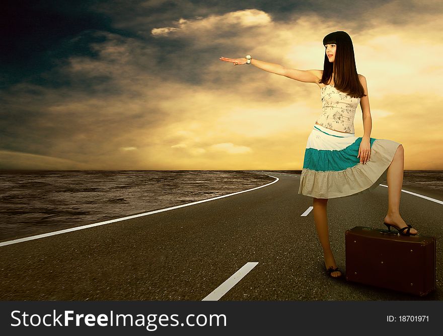 Young woman waiting on the road with her vintage baggage. Young woman waiting on the road with her vintage baggage