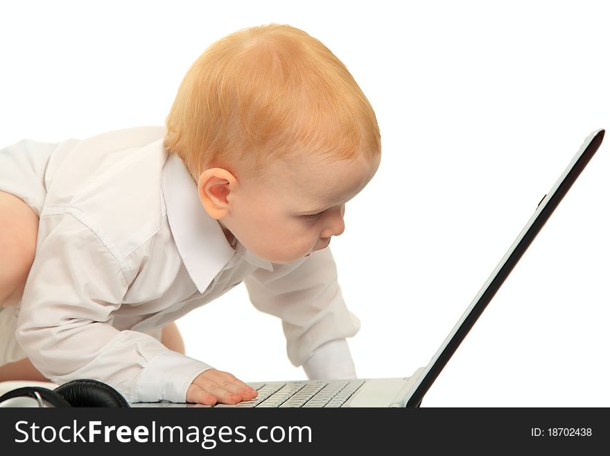 Small child looks at a laptop on a white background. Small child looks at a laptop on a white background