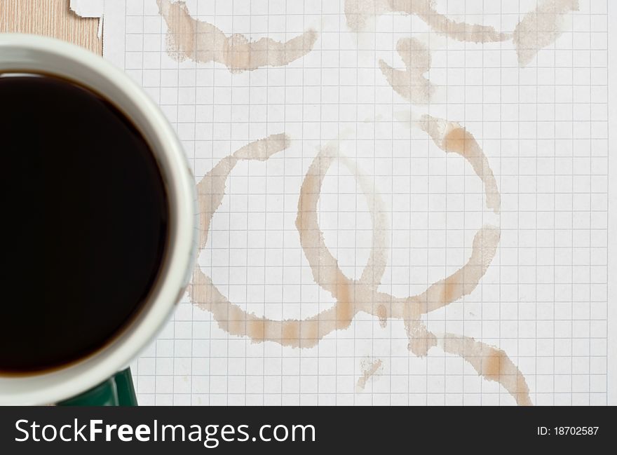 Coffee rings and cup of coffee stains on white paper background