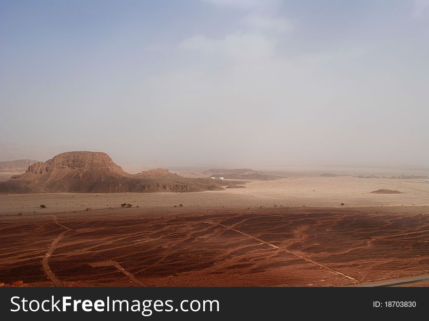 Mountain, surrounded by brown desert sand. Mountain, surrounded by brown desert sand