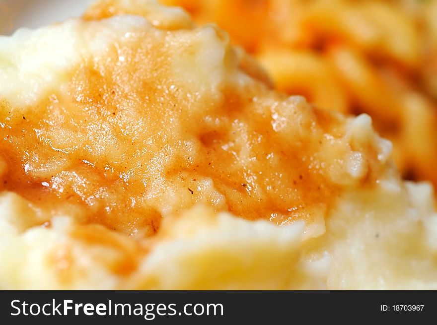 Macro shot of mashed potatoes topped with delicious gravy. Macro shot of mashed potatoes topped with delicious gravy.