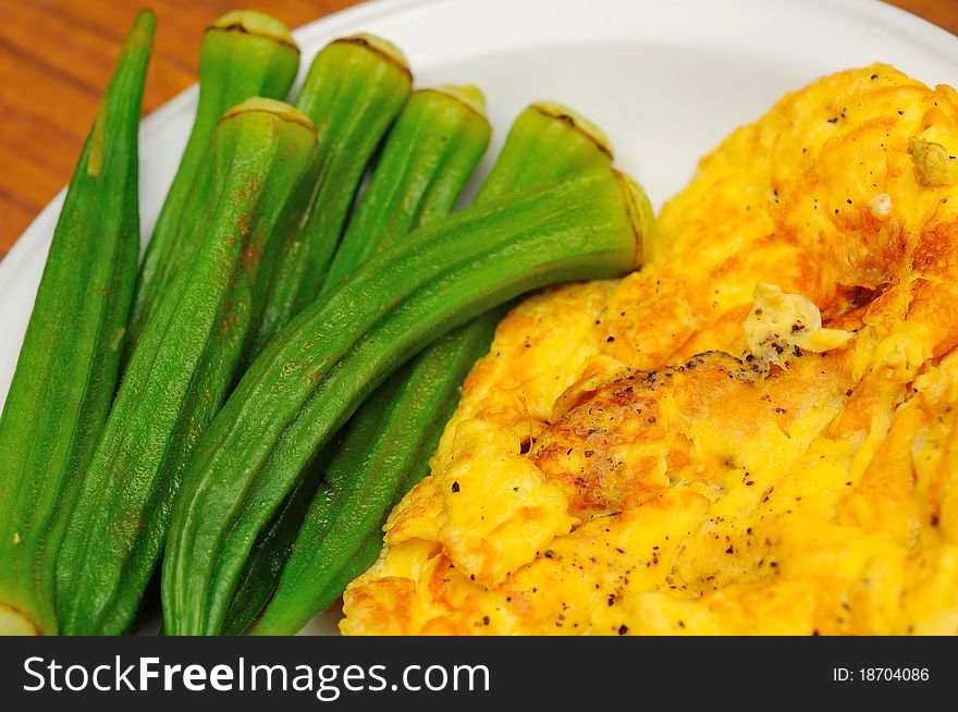 Simple dish of okra and fried omelet as side dishes. Simple dish of okra and fried omelet as side dishes.
