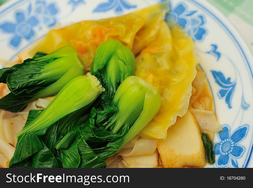 Tasty delicacy of steamed dumplings and green vegetables. Tasty delicacy of steamed dumplings and green vegetables.