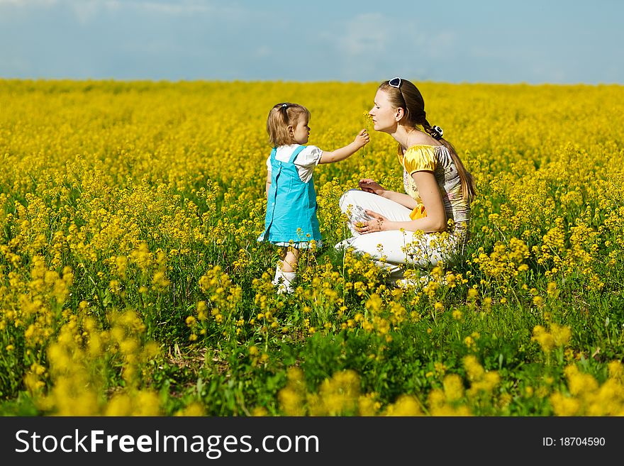 Mother with baby on yellow field