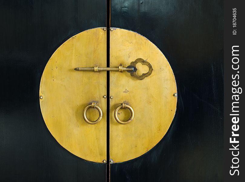 Golden key in the door of old cabinet wood. Golden key in the door of old cabinet wood