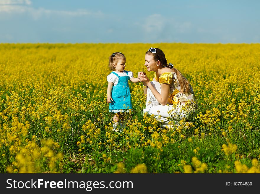 Mother with baby on yellow field