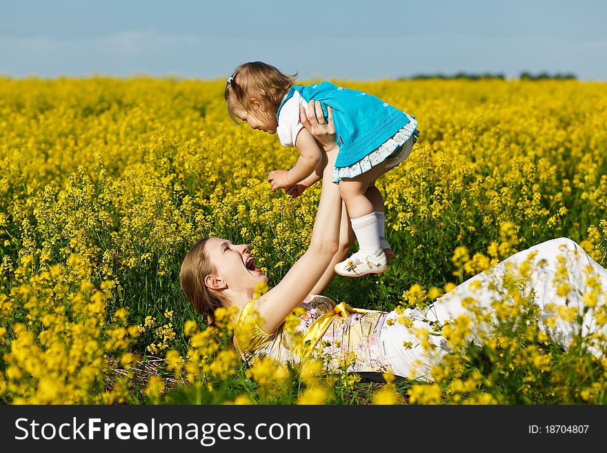 Mother with baby on yellow field