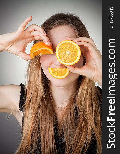 Girl Using Orange As Eyes, With Grey Background