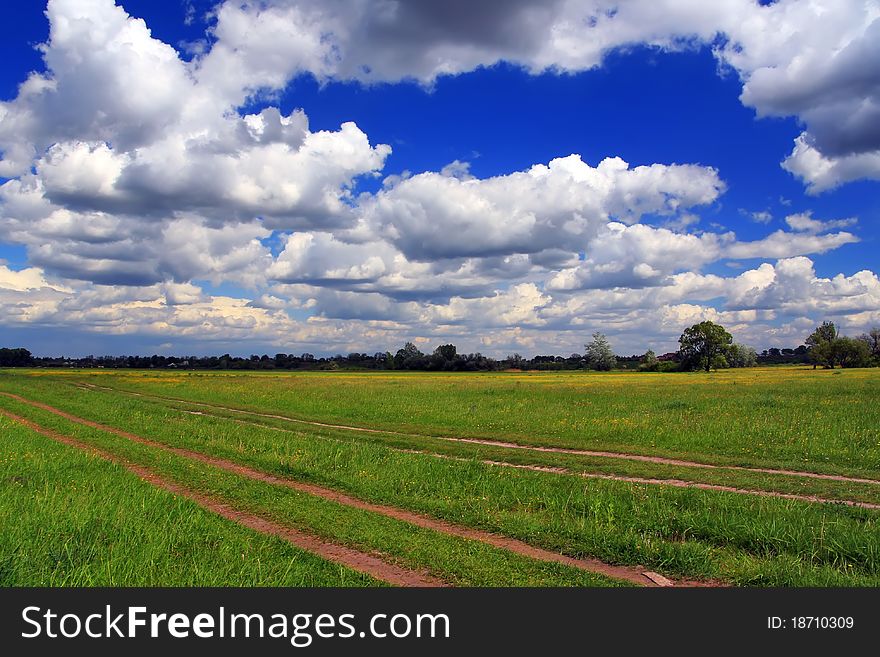 Summer field with cumulus clouds. Summer field with cumulus clouds