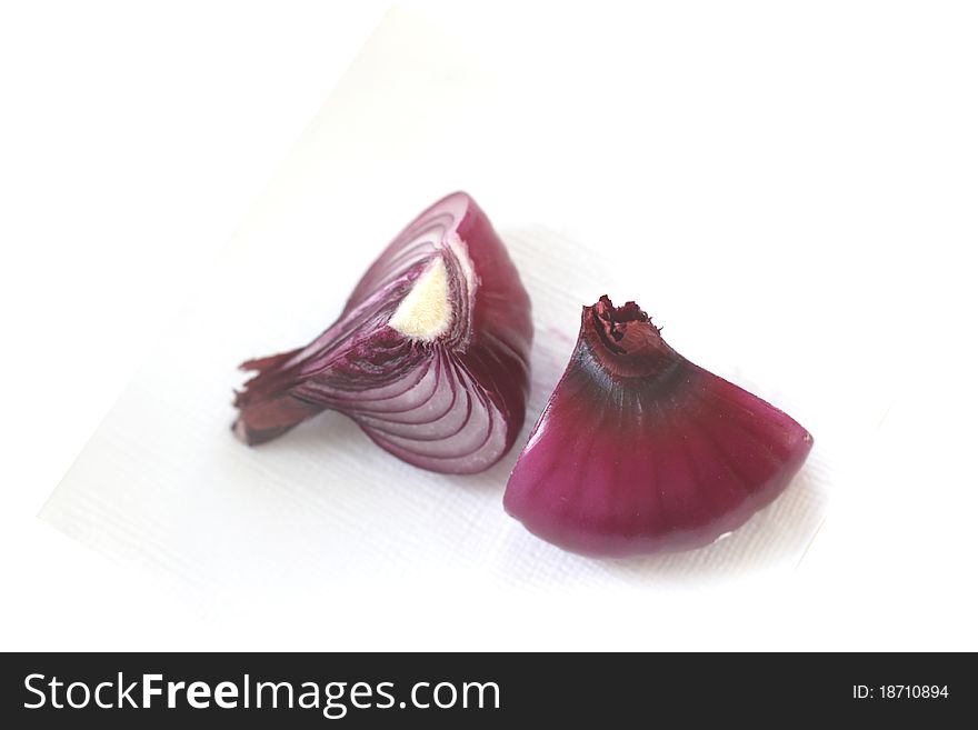 Two quarters of red onion on white background