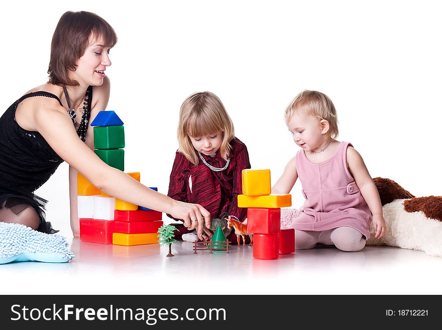 Children with mother playing with blocks