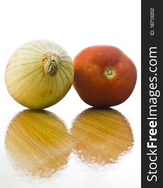 Onion and tomato with surface of wood table
