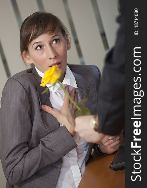 Man giving rose as a gift to a female office worker