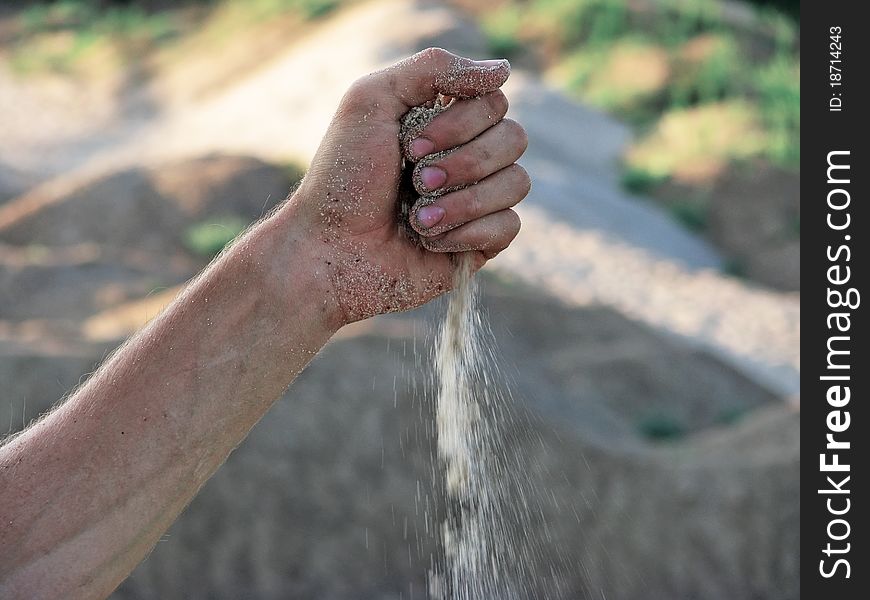 Sand falls from the hand. Sand falls from the hand