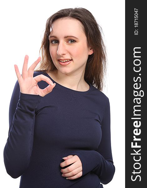 Beautiful happy young girl gives positive okay hand sign, wearing a navy blue long sleeve t-shirt. Beautiful happy young girl gives positive okay hand sign, wearing a navy blue long sleeve t-shirt.
