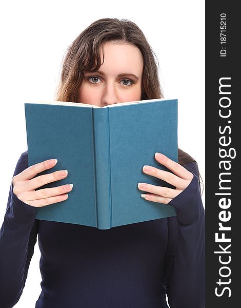 Young brunette woman looking up from behind a book she is reading. Young brunette woman looking up from behind a book she is reading.