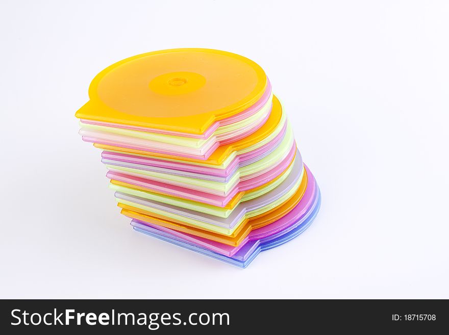 Colorful plastic cd covers stacked up out on a white background