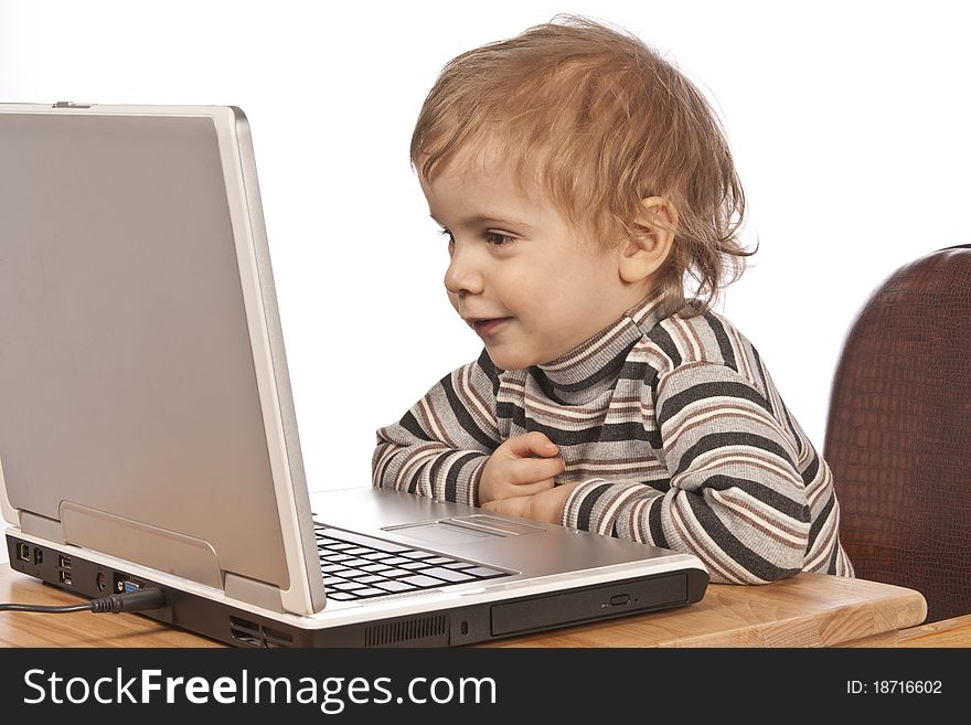 Little child and laptop. Isolated on white background