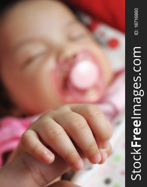 Close up of a baby hand with blurred baby background. Close up of a baby hand with blurred baby background