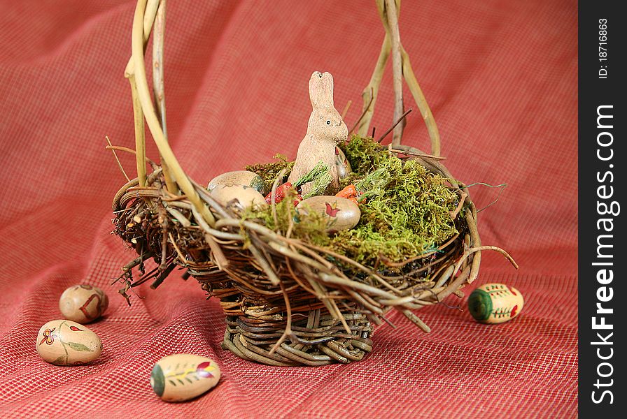 Vintage Easter basket with wooden bunny and hand-painted eggs with Americana color scheme. Vintage Easter basket with wooden bunny and hand-painted eggs with Americana color scheme.