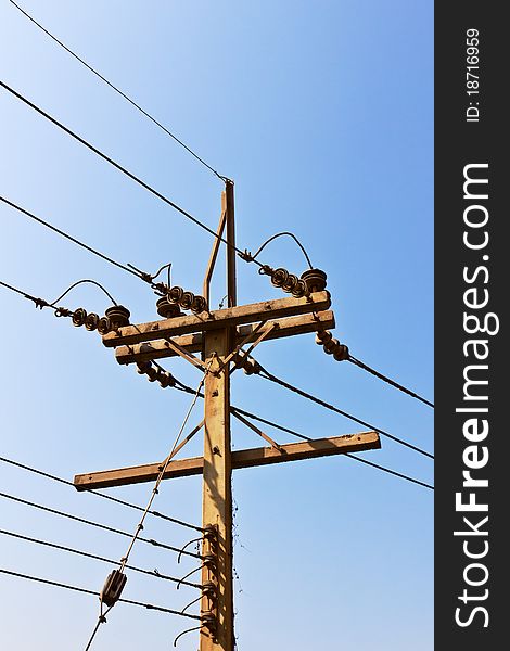 A pole with power lines transporting electricity. A pole with power lines transporting electricity.