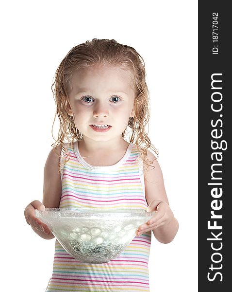 A nervous girl holding a glass bowl. The bowl has a ball of light inside of it. The light is glowing onto her face.