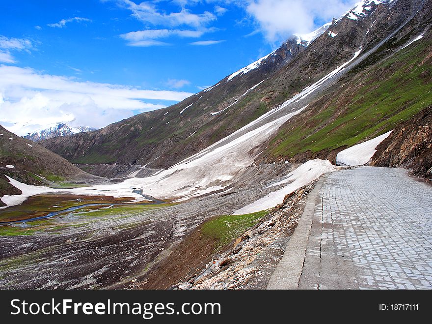 An exotic landscape with beautiful blue sky,green mountains with dramatic sky. An exotic landscape with beautiful blue sky,green mountains with dramatic sky.