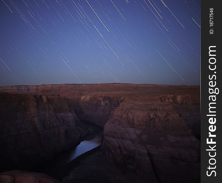 Early dawn starstreaks over Horseshoe Bend viewpoint at Glenn Canyon near Page, Arizona.