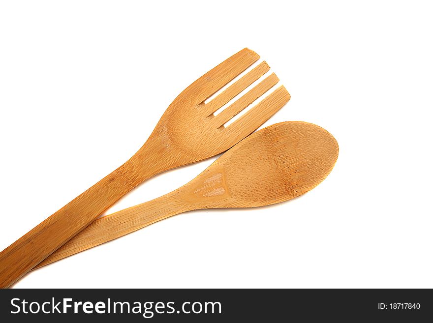 Wooden spoon and fork over white