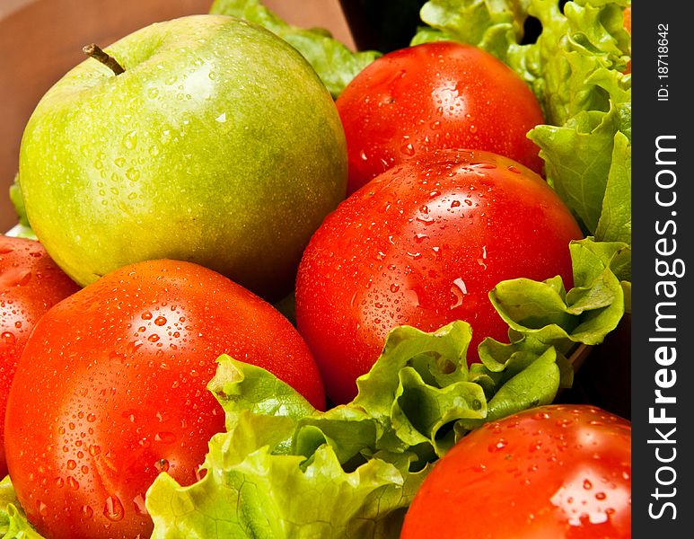 Tomatoes with fresh salad and a green apple. Tomatoes with fresh salad and a green apple