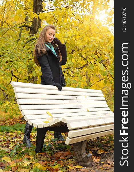 Woman in autumn near bench