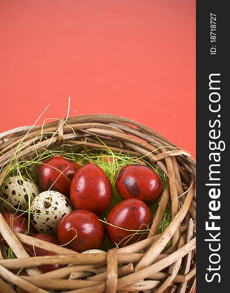 Easter eggs in basket on red background