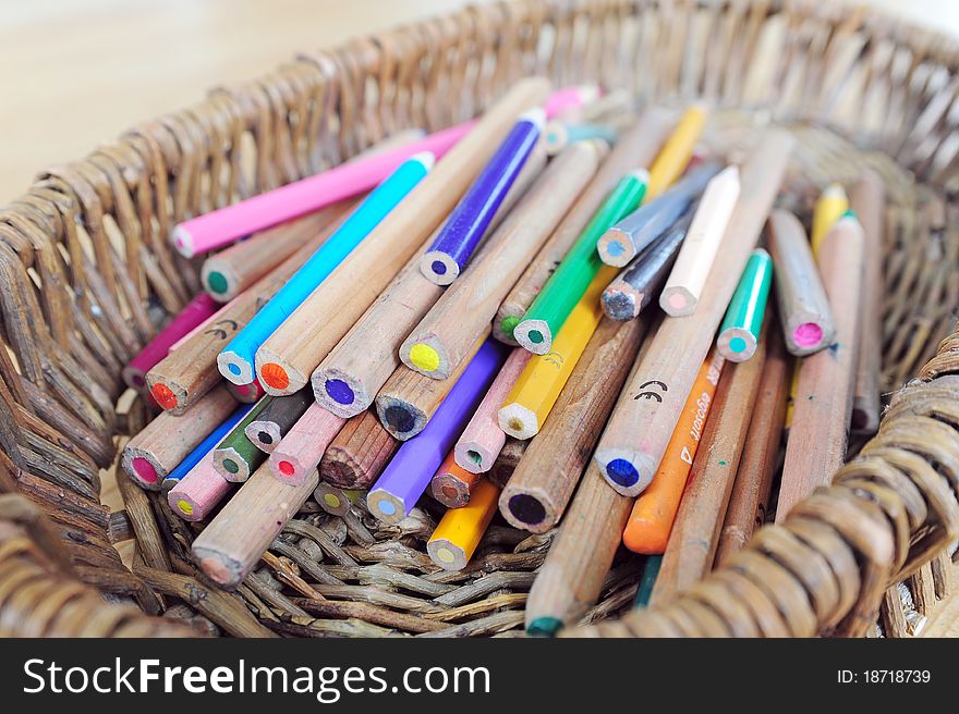 A heap of colour pencils in a basket. A heap of colour pencils in a basket
