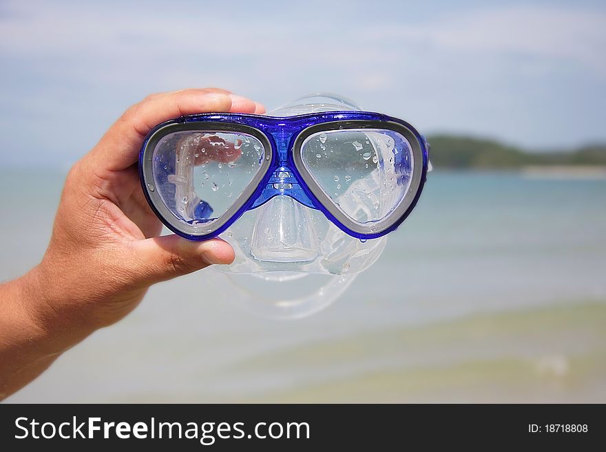 Blue diving mask on sea background