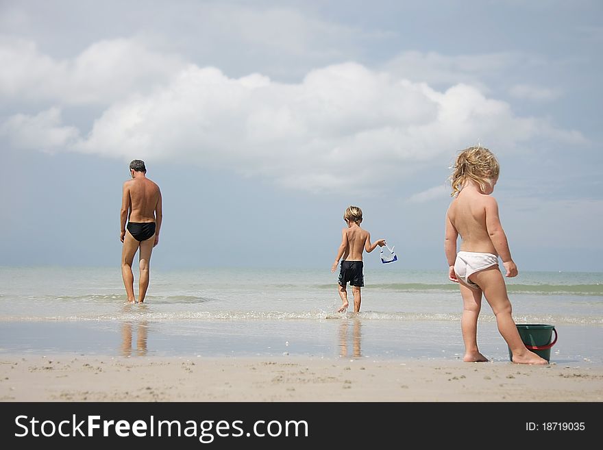 Father and two kids on beach
