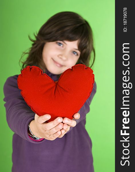 Happy little girl with red valentines heart