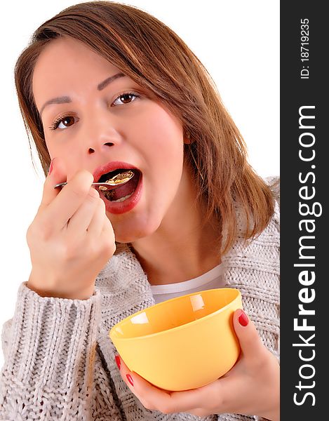 Happy young woman eating cereals