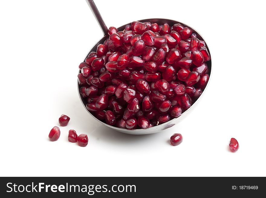 Many seeds with pomegranate on a white background