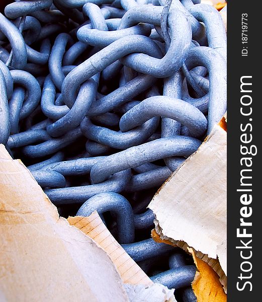 Bluish thick steel chain and cardboard packaging, contrast solid and tearable. Bluish thick steel chain and cardboard packaging, contrast solid and tearable