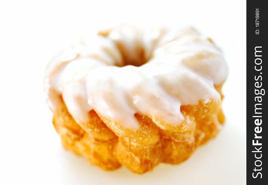 Cruller with icing isolated on white studio background
